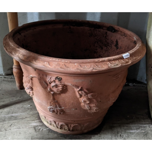 504 - Five terracotta garden planters to include a large planter of tapering form with cast floral swags, ... 