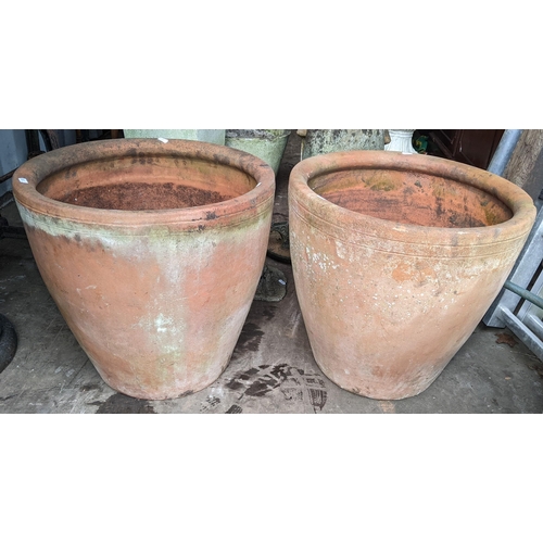 504 - Five terracotta garden planters to include a large planter of tapering form with cast floral swags, ... 