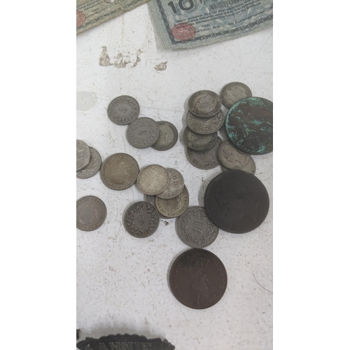 513 - A mixed lot to include silver British coinage and others together with German notes, cap badges and ... 