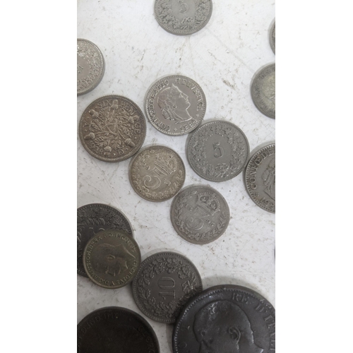 513 - A mixed lot to include silver British coinage and others together with German notes, cap badges and ... 