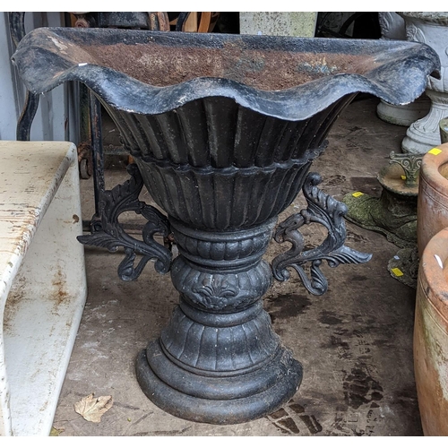 518 - A cast iron black painted demi lune planter having a wavy border with a reeded body and scroll cast ... 