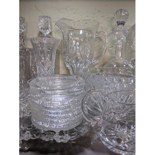 524 - A collection of glassware to include decorative plates, drinking glasses, decanters, serving jugs, b... 