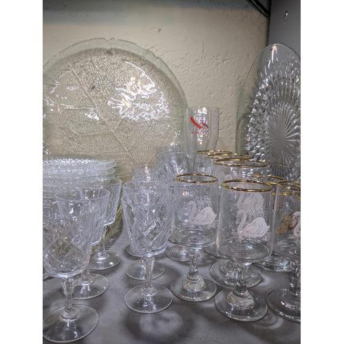 524 - A collection of glassware to include decorative plates, drinking glasses, decanters, serving jugs, b... 