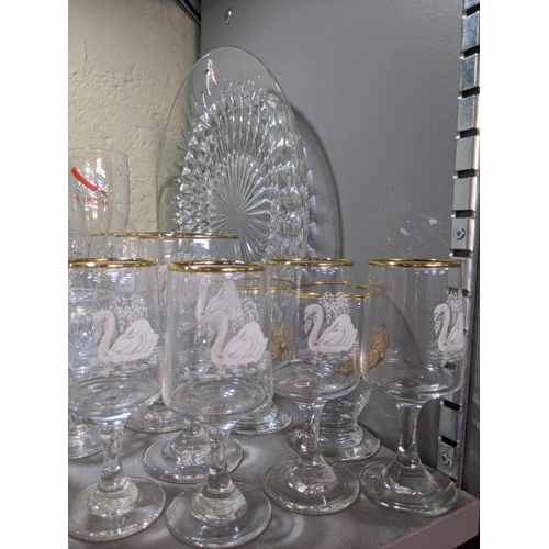 524 - A collection of glassware to include decorative plates, drinking glasses, decanters, serving jugs, b... 