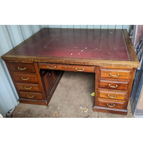 528 - A mid 20th century mahogany twin pedestal partner's desk having a red leather topped scriber and nin... 