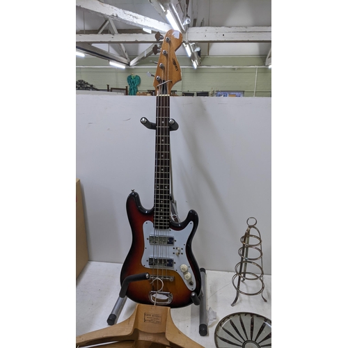 534 - A mixed lot to include a 'Satellite' bass guitar on a stand, two Portuguese wooden vintage coat hang... 