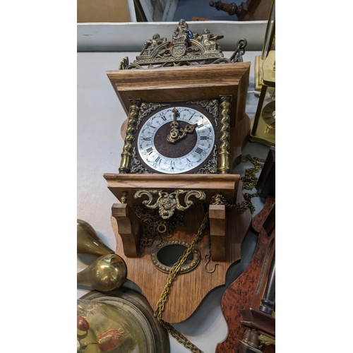 535 - A mixed lot of clocks to include two glass domed skeleton clocks, two cased wall clocks and others
L... 