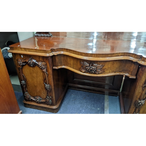 305 - A fine and large Victorian mahogany sideboard carved with vine leaf decoration (closely following th... 