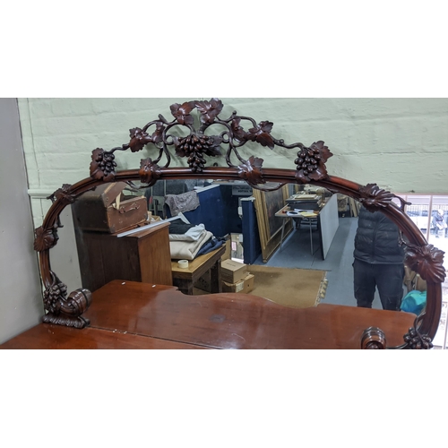 305 - A fine and large Victorian mahogany sideboard carved with vine leaf decoration (closely following th... 