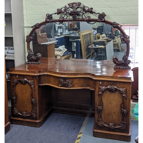 305 - A fine and large Victorian mahogany sideboard carved with vine leaf decoration (closely following th... 