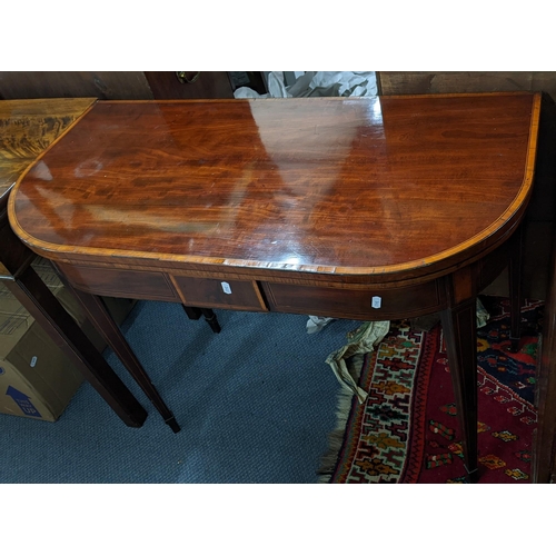 310 - A George III Sheraton mahogany and satinwood inlaid card table raised on square taper supports, with... 