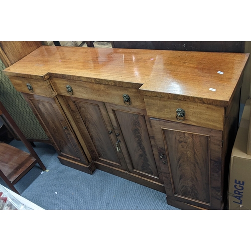 379 - A small Regency inverted breakfront mahogany sideboard having three drawers above four doors, 89.5cm... 