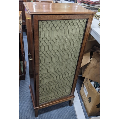 380 - A Regency mahogany side cabinet on square taper supports with brass wire silk backed grills to the d... 