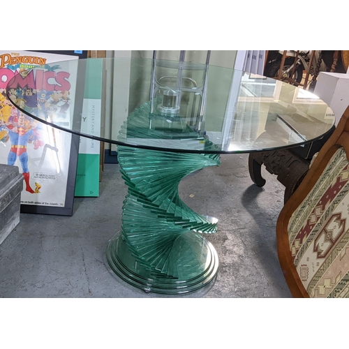 404 - A vintage contemporary circular glass topped dining table having a spiral stepped base 71cm h x 104.... 