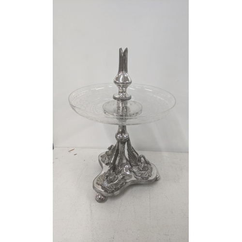 543 - A silver plated and glass pedestal dish having an etched glass bowl with a cast swan base on three b... 