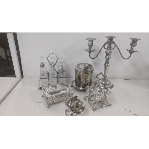 545 - A collection of silver plated items to include a six-piece cruet set, a three branch candelabra, a b... 