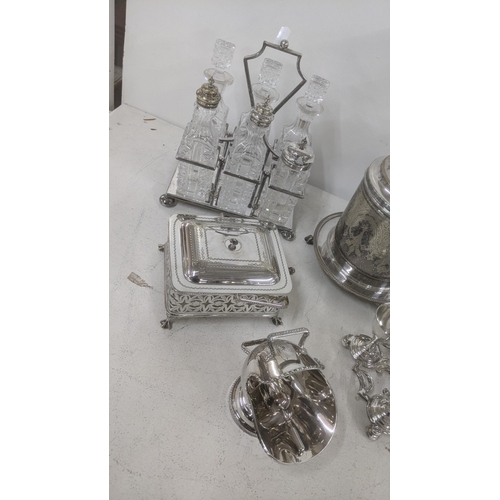 545 - A collection of silver plated items to include a six-piece cruet set, a three branch candelabra, a b... 