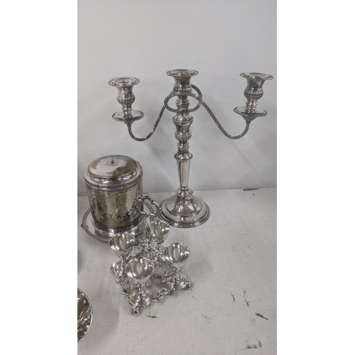 545 - A collection of silver plated items to include a six-piece cruet set, a three branch candelabra, a b... 