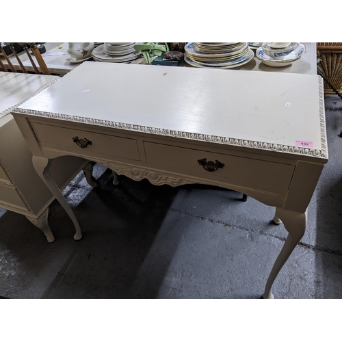 535 - A white painted two drawer dressing table, standing on cabriole legs and pad feet, 77cm x 97cm x 44.... 