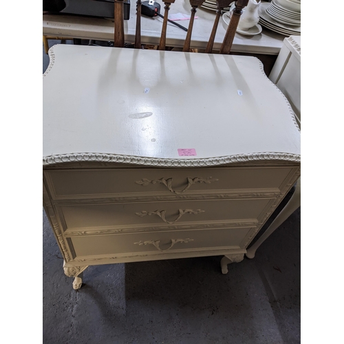 535 - A white painted two drawer dressing table, standing on cabriole legs and pad feet, 77cm x 97cm x 44.... 