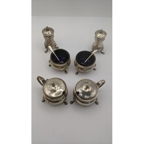 12 - Sterling silver condiment pots to include two mustard, two salts with glass liners and two pepper po... 