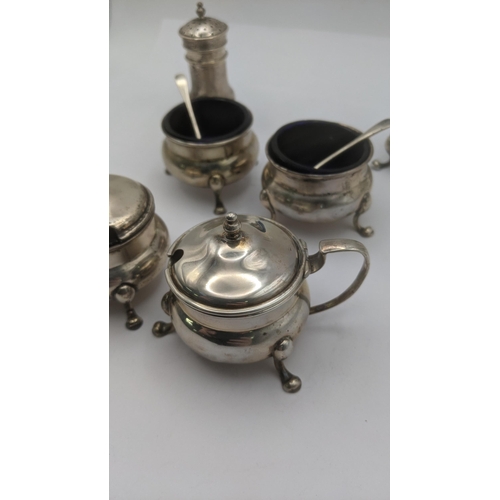 12 - Sterling silver condiment pots to include two mustard, two salts with glass liners and two pepper po... 