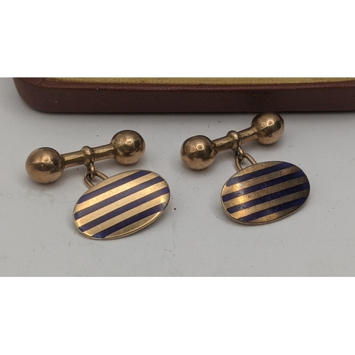 21 - A pair of yellow gold and blue enamel cufflinks, tested as 9ct gold in oval form and blue enamel str... 