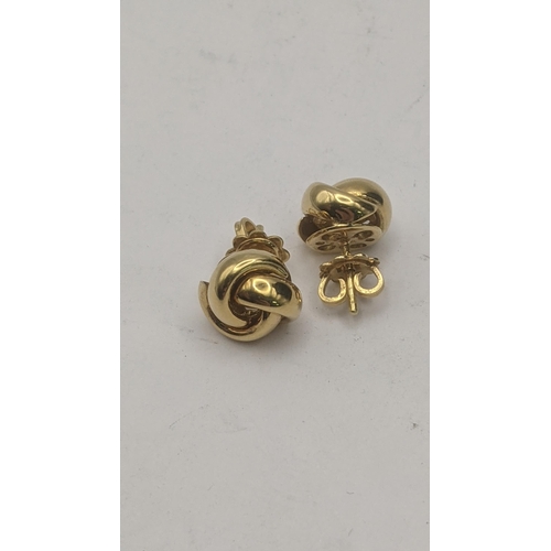 23 - A pair of 18ct yellow gold knot style stud earrings, 10.9mm dia, 5.7g
Location:CAB1
If there is no c... 