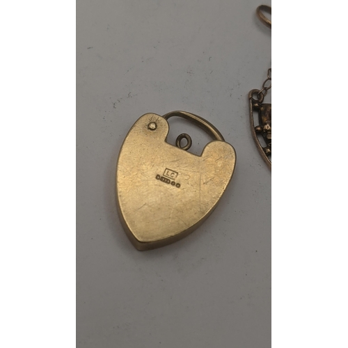 24 - A 9ct yellow gold heart shaped padlock clasp pendant, 3.2g, together with a 9ct yellow gold Art Nouv... 