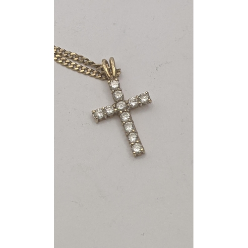 36 - A 9ct yellow gold and paste stone crucifix pendant set with eleven brilliant cut paste stones in fou... 