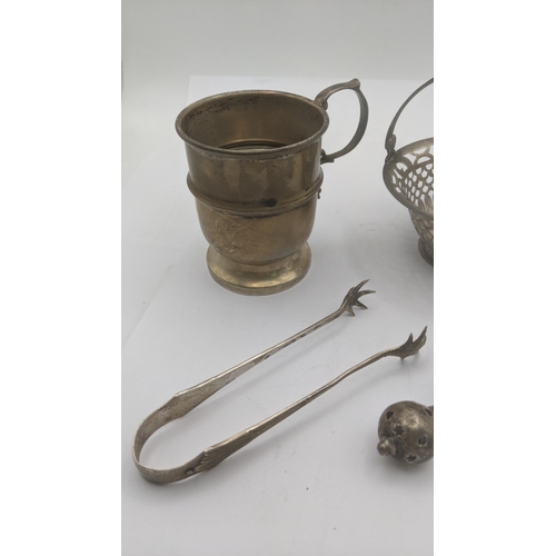 4 - Silver to include a Christening cup hallmarked Birmingham 1965, silver toy rattle, sugar tongs and a... 