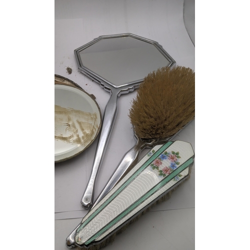 51 - A silver dressing table set and a chrome dressing table set, to include hand mirrors and brushes
Loc... 