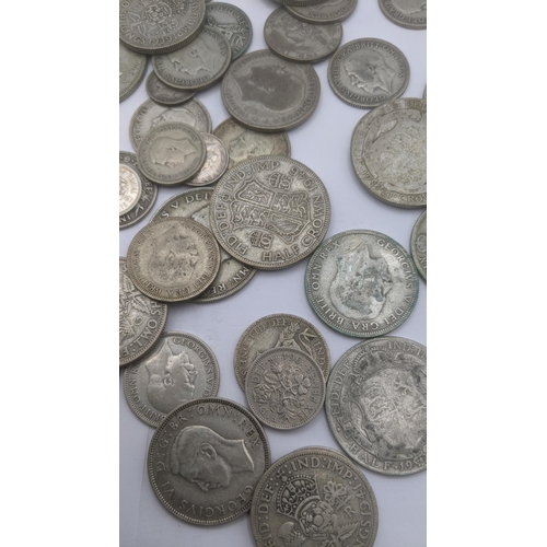 69 - A collection of pre 1946 silver British coinage to include three pence coins, florins and two shilli... 