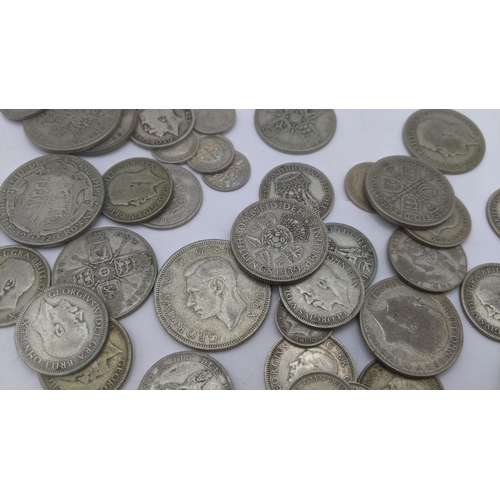 69 - A collection of pre 1946 silver British coinage to include three pence coins, florins and two shilli... 