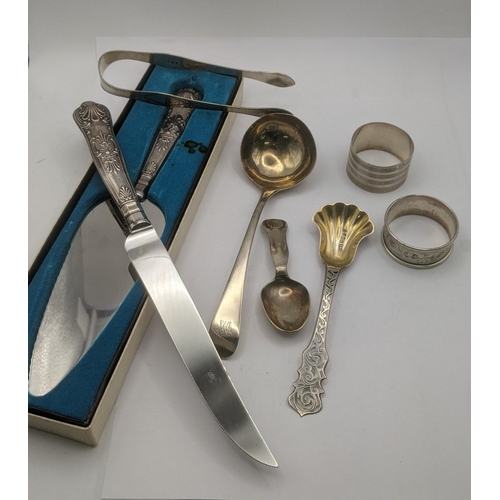 8 - Silver to include a sauce ladle, tea caddy spoon with a floral pierced terminal and a pair of sugar ... 