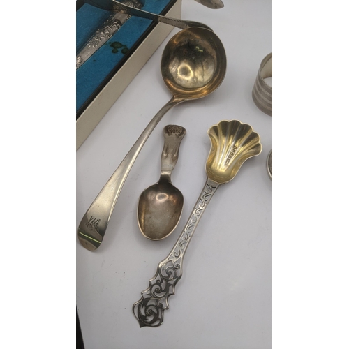 8 - Silver to include a sauce ladle, tea caddy spoon with a floral pierced terminal and a pair of sugar ... 