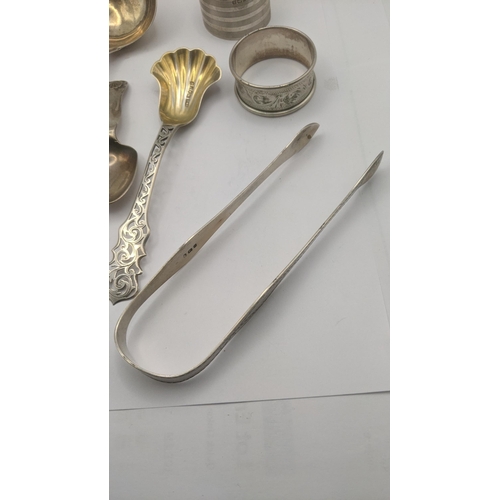 8 - Silver to include a sauce ladle, tea caddy spoon with a floral pierced terminal and a pair of sugar ... 