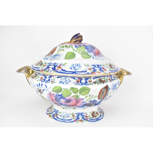 14 - An early 19th century tureen and stand, circa 1820, transfer-printed in underglaze blue and overpain... 