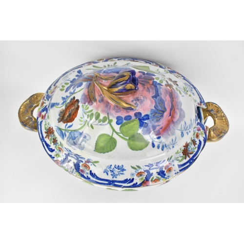 14 - An early 19th century tureen and stand, circa 1820, transfer-printed in underglaze blue and overpain... 