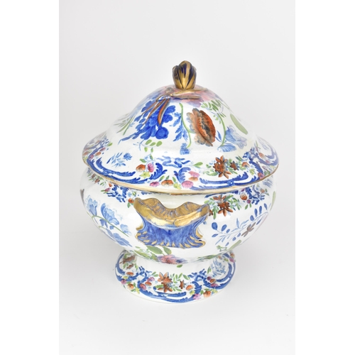 14 - An early 19th century tureen and stand, circa 1820, transfer-printed in underglaze blue and overpain... 