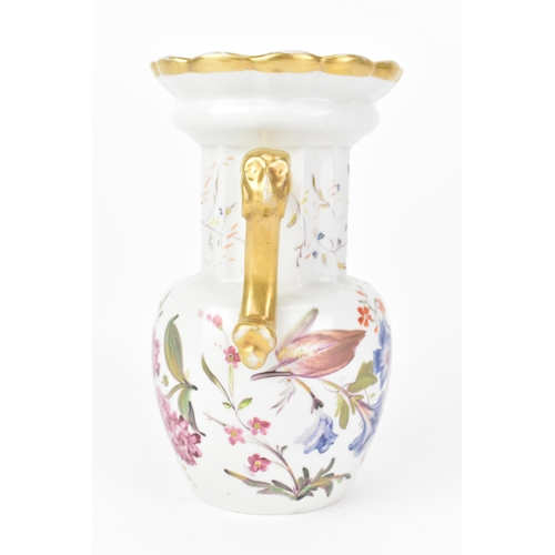 19 - An early 19th century Masons vase, circa 1820-30, having a fluted neck, flaring rim and ornate handl... 