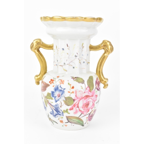 19 - An early 19th century Masons vase, circa 1820-30, having a fluted neck, flaring rim and ornate handl... 