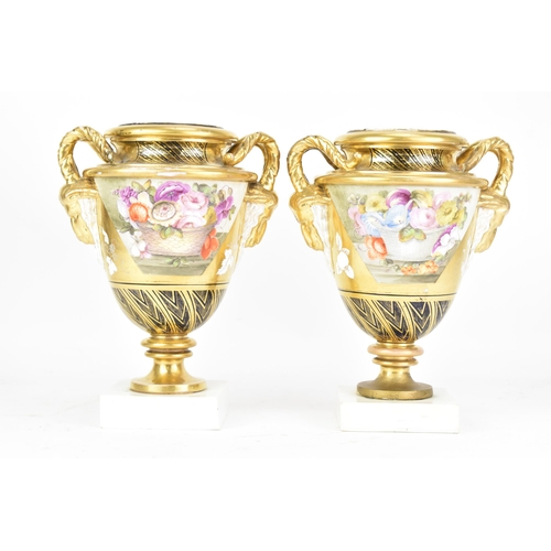 A pair of early 19th century Masons bone china vases, circa 1810-15, each of amphora shape with goat's-head handles, decorated in enamel colours with panels of flowers of one side and panels enclosing painted fruit on the other, illustrated in 'Mason's The first Two Hundred Years' by Gaye Blake Roberts, refence no 23 page 47, 21.5cm high