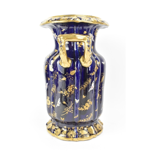 25 - An early 19th century Masons twin handled vase, with mazarine-blue ground, painted in an oriental st... 