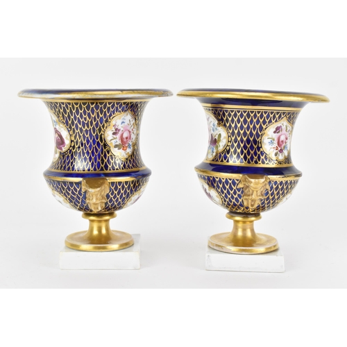 42 - A pair of early 19th century Masons bone china vases, circa 1810-12, of campagna form painted in cob... 