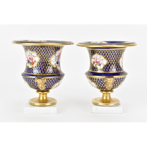 42 - A pair of early 19th century Masons bone china vases, circa 1810-12, of campagna form painted in cob... 