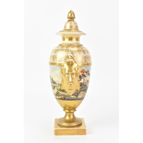 44 - An early 19th century Masons lidded vase, the centre hand-painted depicting a continuous landscape s... 