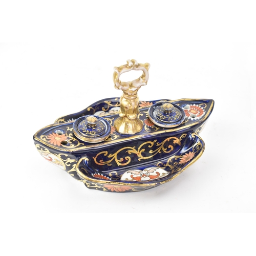 57 - Two 19th century Masons inkwells, to include one on a cobalt blue ground with panels of flowers, two... 