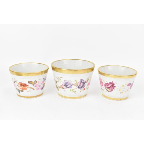 69 - An early 19th century Masons garniture of three ironstone flower-pots and stands, each hand-painted ... 