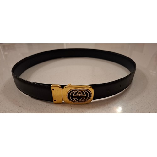 4 - Gucci- A black leather belt with gold tone double GG buckle, made in Italy, waist measurement 81cm -... 